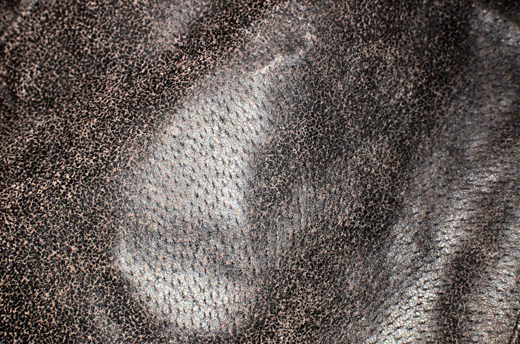 Full frame textured background of uneven natural leather fabric made of animal skin